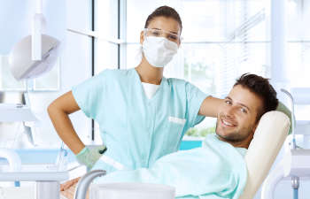 dentist and patient looking at the camera