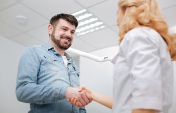 patient shaking hands with the dentist