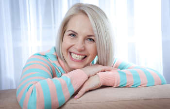 older woman smiling to the camera