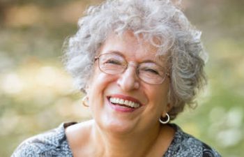 older woman smiling to the camera